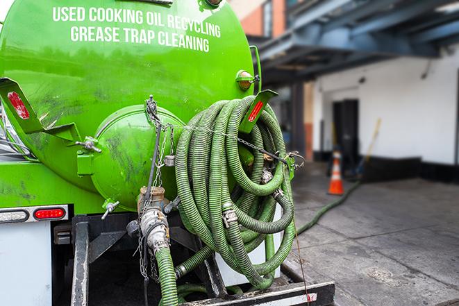 a professional technician pumping a restaurant's grease trap in Jamestown, NC